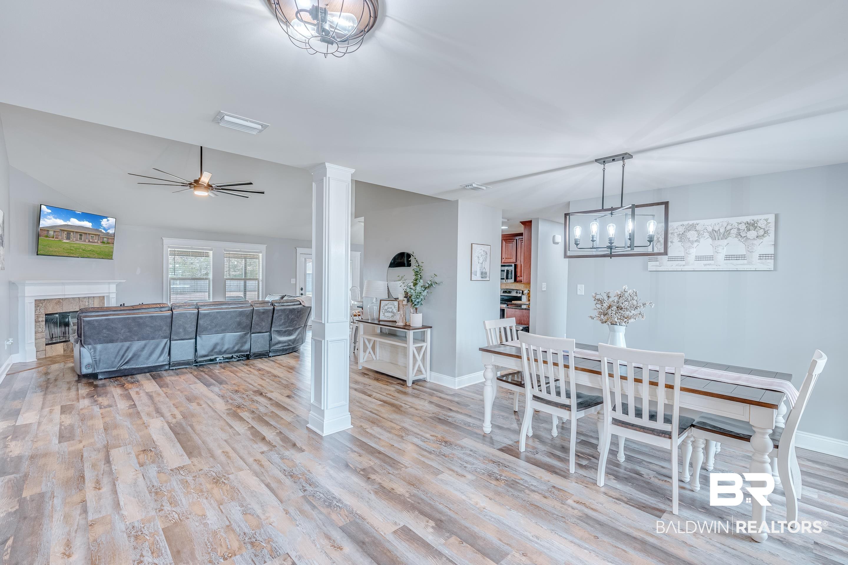 13235 Tom Gaston Road Mobile, AL 36695 - Photo 3 of 43 Dining area with light wood-type flooring, vaulted ceiling, ceiling fan, and ornate columns