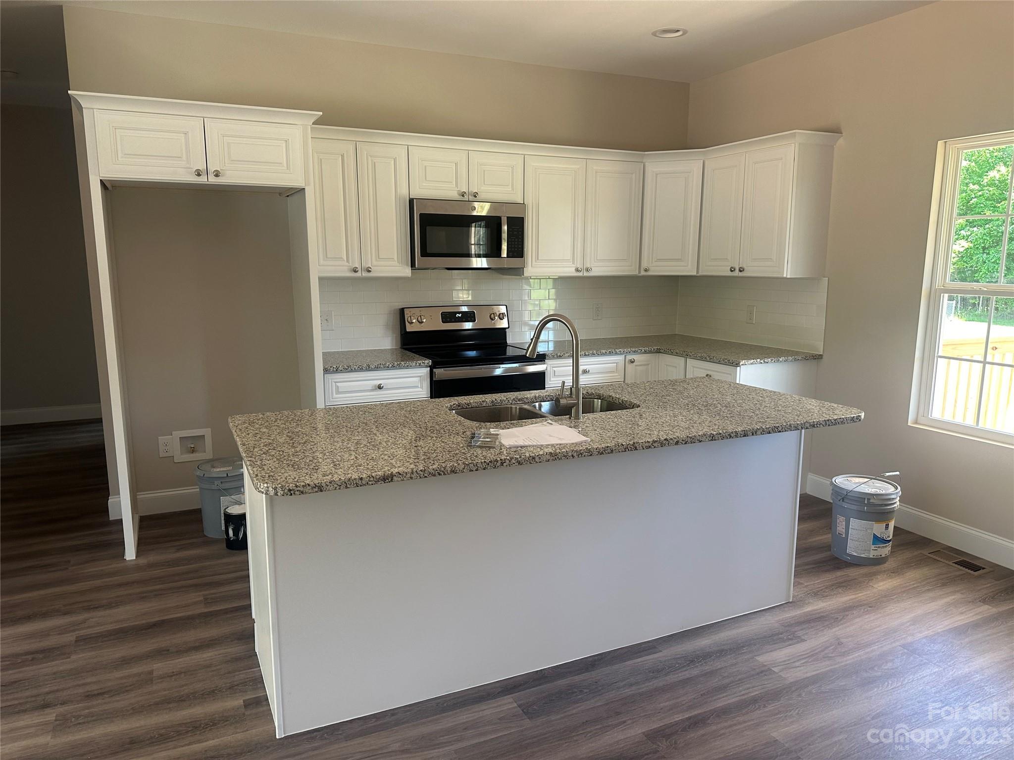 3005 Greenleaf Road Clover, SC 29710 - Photo 8 of 20 a kitchen with granite countertop a stove a sink and a microwave