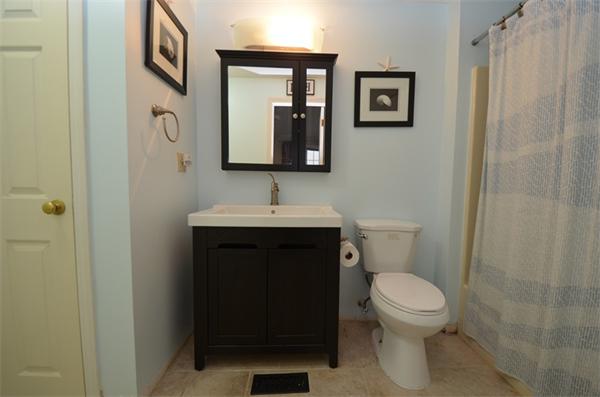 12 Perley Road, Unit 23D Derry, NH 03038 - Photo 14 of 20 a bathroom with a toilet sink and mirror