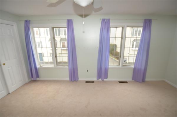 12 Perley Road, Unit 23D Derry, NH 03038 - Photo 16 of 20 an empty room with windows