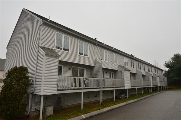 12 Perley Road, Unit 23D Derry, NH 03038 - Photo 20 of 20 a large white building with a large window and wooden fence