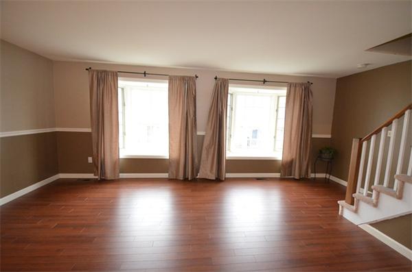 12 Perley Road, Unit 23D Derry, NH 03038 - Photo 6 of 20 a view of an empty room with wooden floor and a window