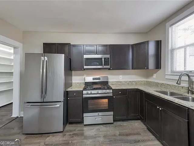 a kitchen with a refrigerator sink and stove