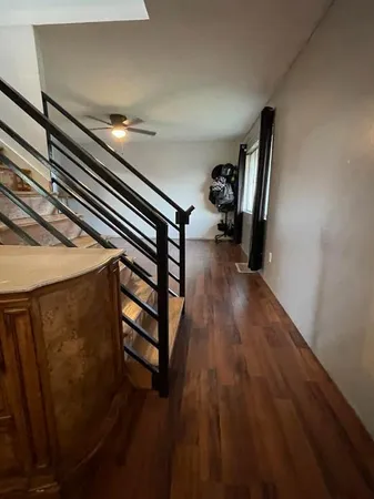a view of entryway and hall with wooden floor