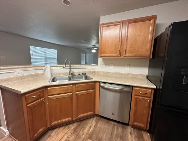 a kitchen with a sink and a stove top oven
