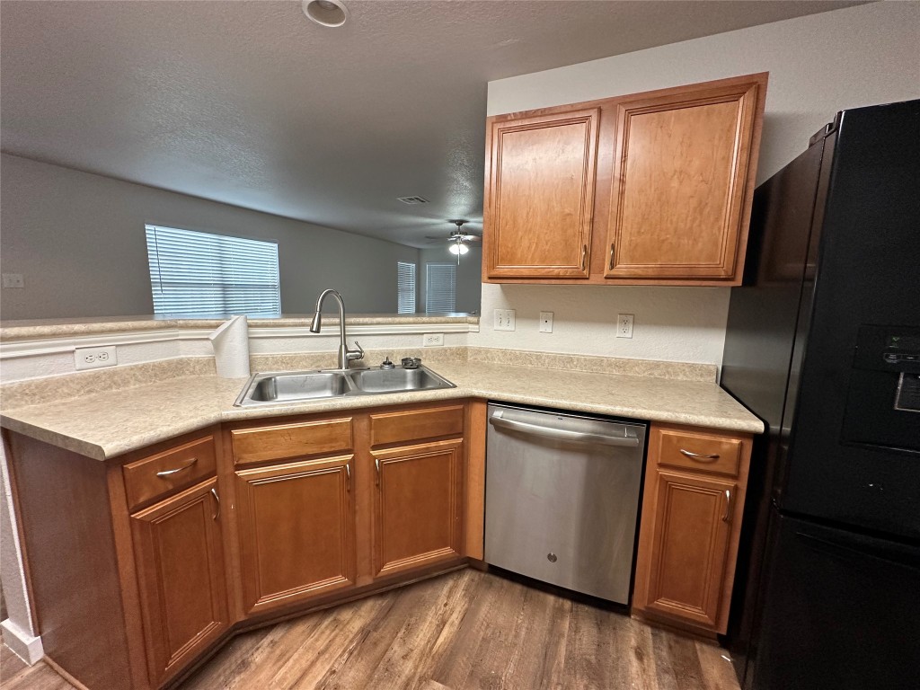 113 Lex Word Kyle, TX 78640 - Photo 9 of 40 a kitchen with a sink stove and refrigerator