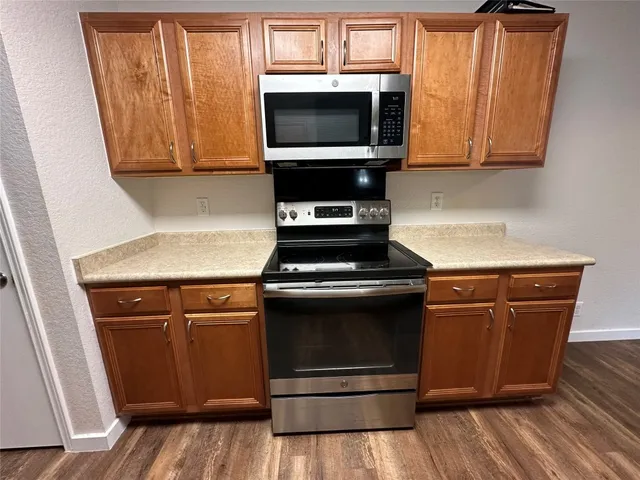 a kitchen with a sink stove and refrigerator