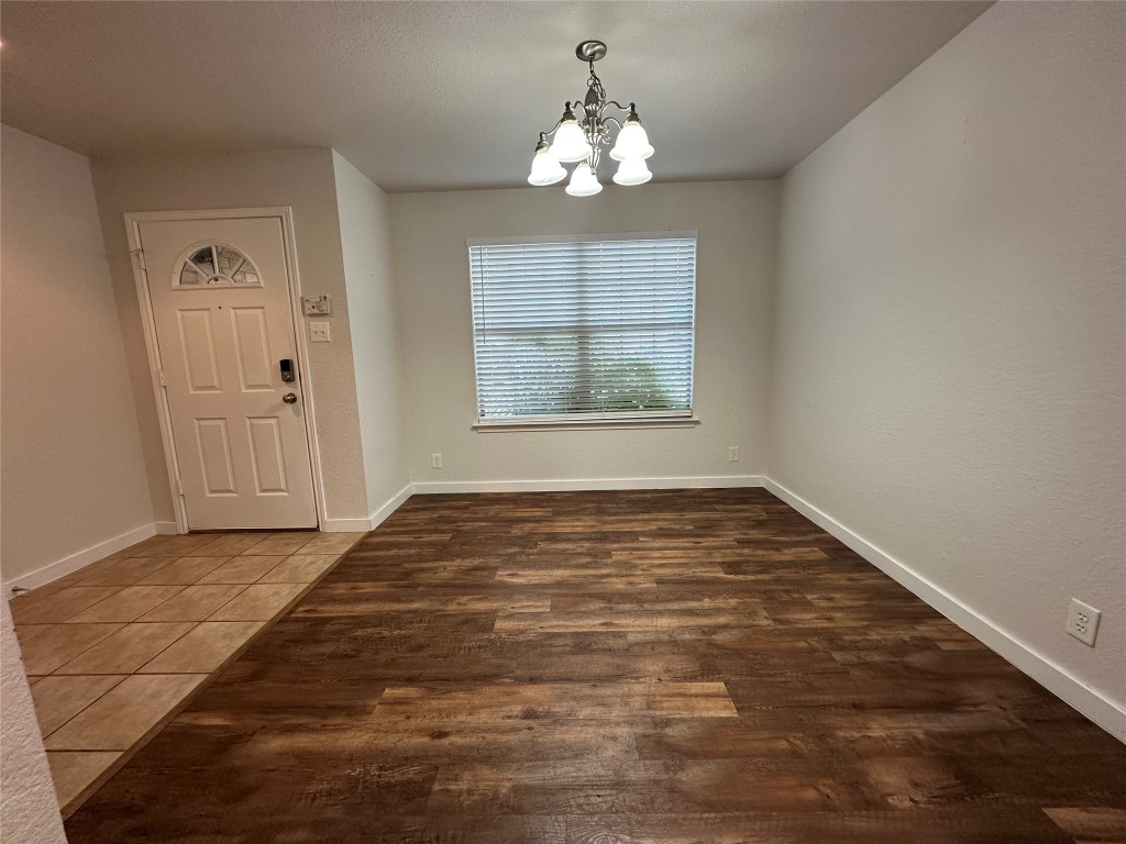 113 Lex Word Kyle, TX 78640 - Photo 12 of 40 a view of an empty room with wooden floor and a window