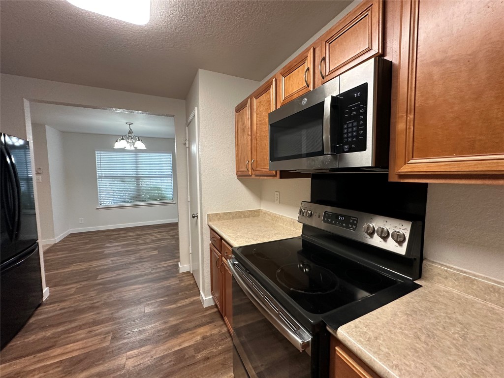 113 Lex Word Kyle, TX 78640 - Photo 14 of 40 a kitchen with a stove and a microwave