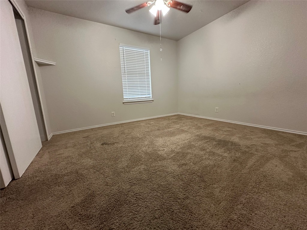 113 Lex Word Kyle, TX 78640 - Photo 21 of 40 an empty room with chandelier fan and windows