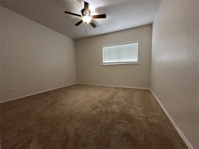 a bathroom with a granite countertop toilet sink and mirror