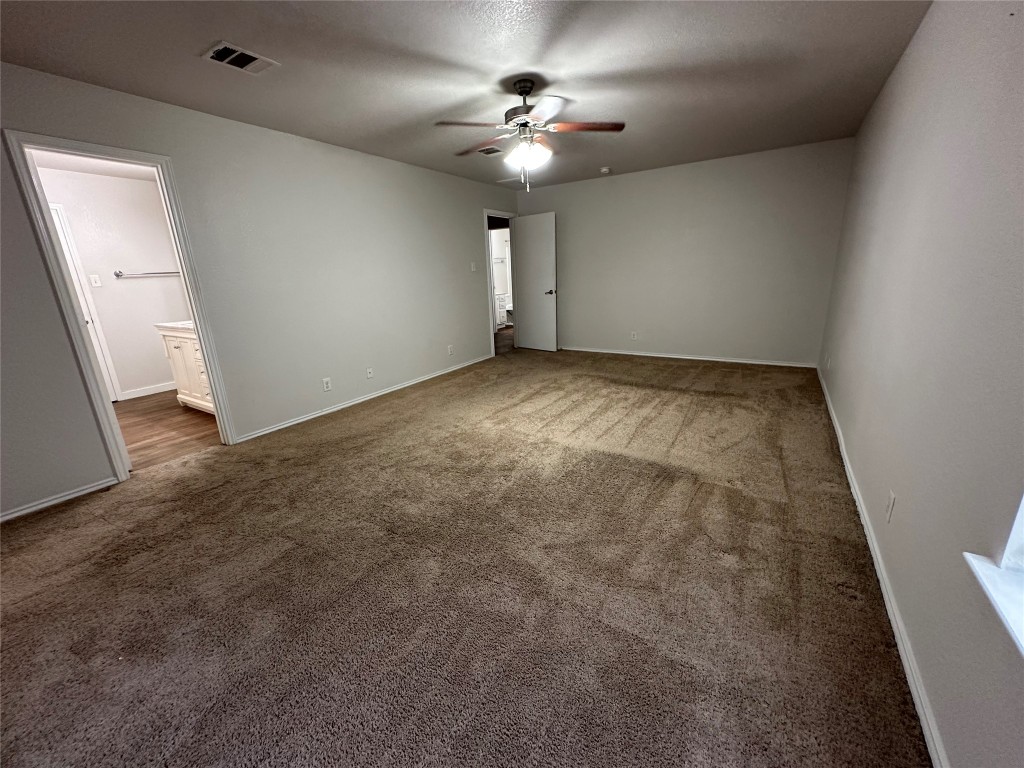 113 Lex Word Kyle, TX 78640 - Photo 29 of 40 an empty room with a ceiling fan and a window