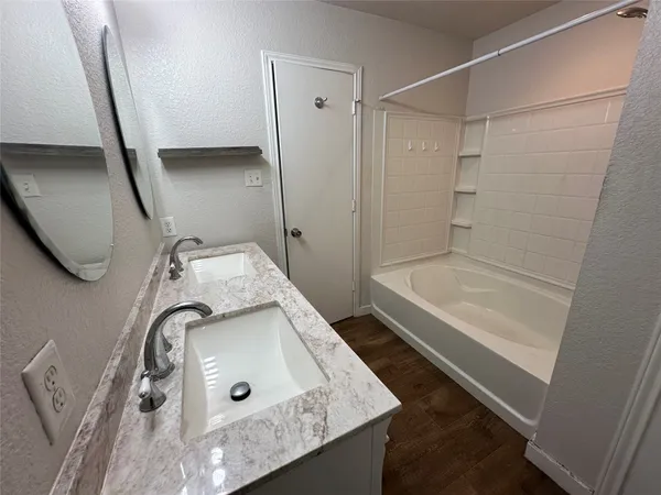 a bathroom with a double vanity sink and a mirror