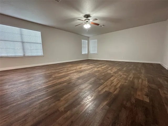 an empty room with wooden floor