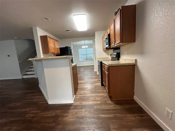 a view of a kitchen with flat screen tv and window