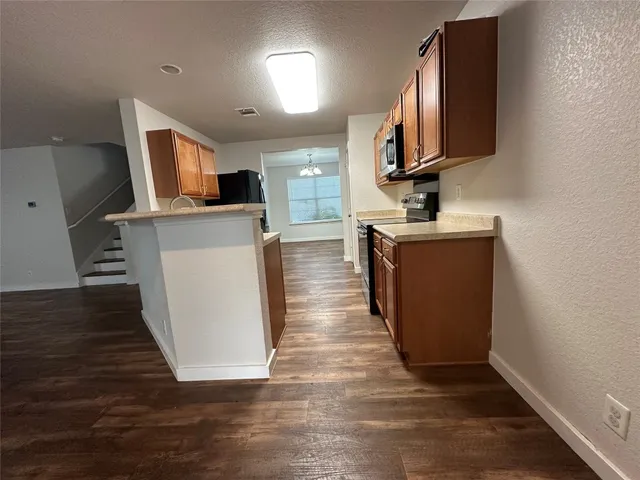 a view of a kitchen with flat screen tv and window