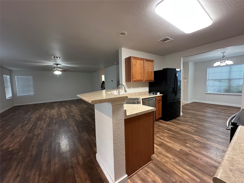 113 Lex Word Kyle, TX 78640 - Photo 40 of 40 a kitchen that has a lot of cabinets in it and wooden floors