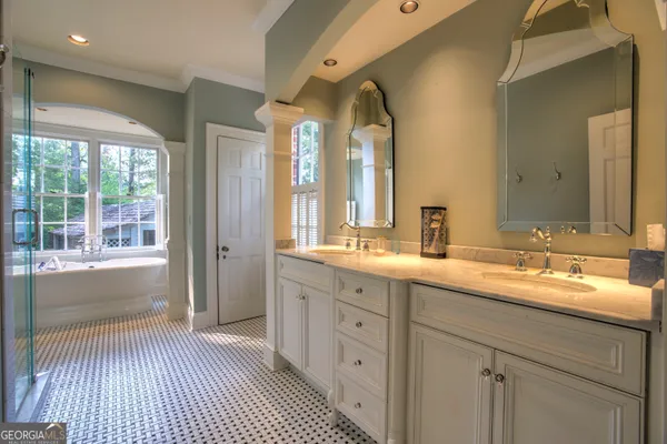 a view of a house with a small yard and large trees