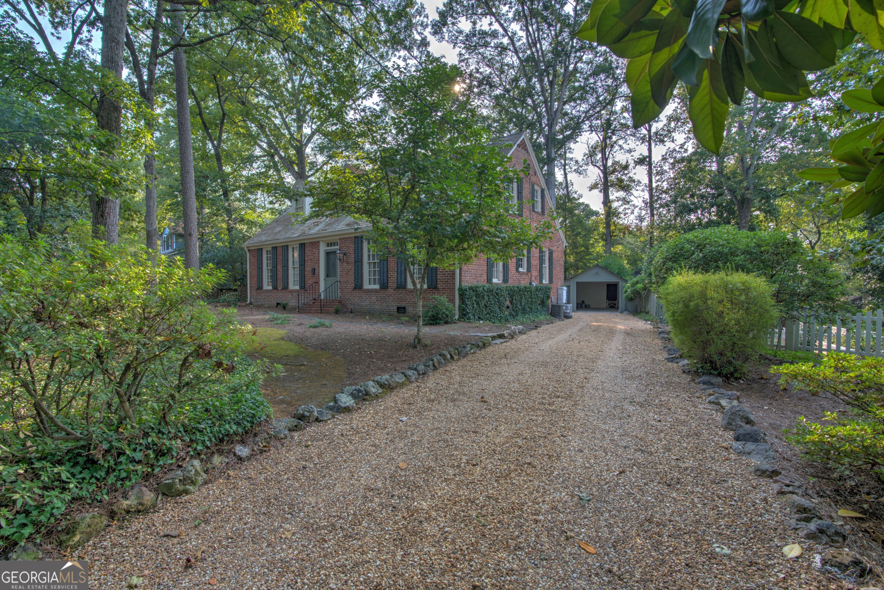 209 Sherwood Road Southwest Rome, GA 30165 - Photo 53 of 71 a view of a house with a small yard and large trees