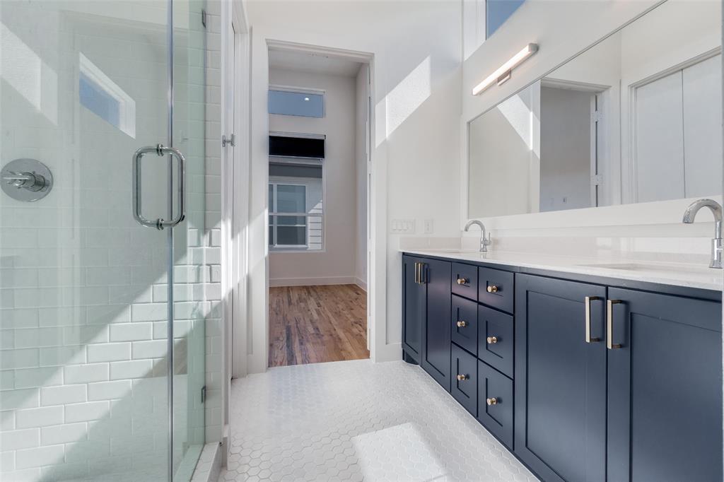4718 Bryan Street, Unit 301 Dallas, TX 75204 - Photo 11 of 12 a bathroom with a sink and mirror