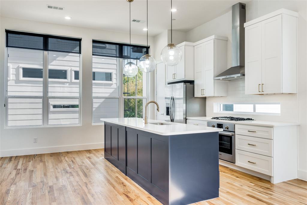 4718 Bryan Street, Unit 301 Dallas, TX 75204 - Photo 5 of 12 a kitchen with stainless steel appliances granite countertop a sink a stove and a refrigerator