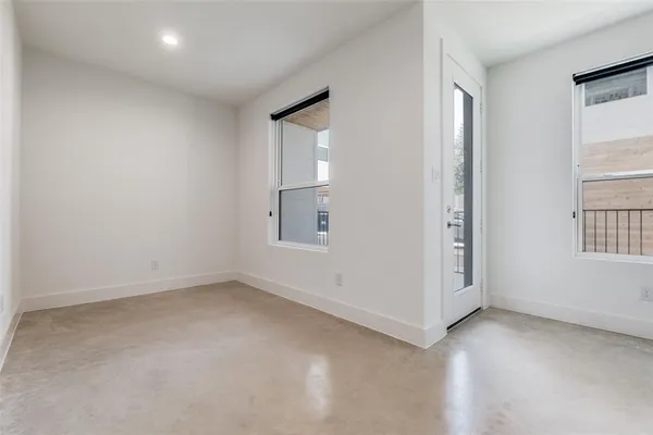 an empty room with windows and closet