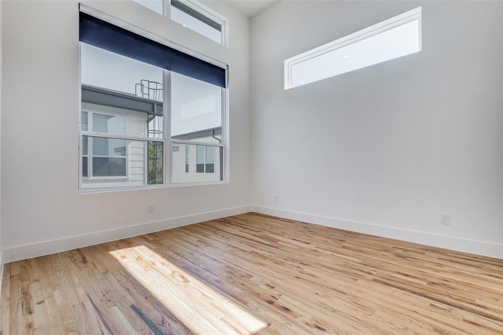 4718 Bryan Street, Unit 301 Dallas, TX 75204 - Photo 9 of 12 a view of empty room with wooden floor and fan
