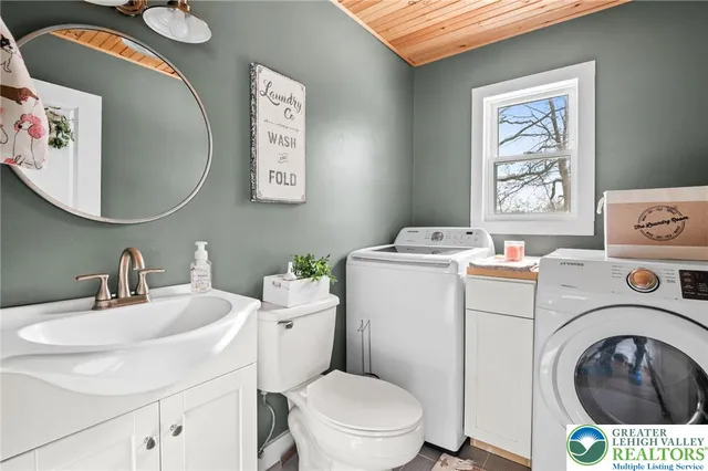 a bathroom with a sink mirror and toilet
