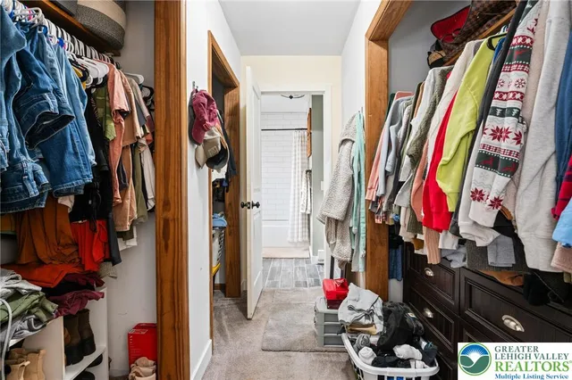 a view of walk in closet with clothes
