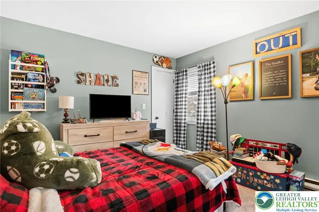 a bedroom with a bed and flat screen tv