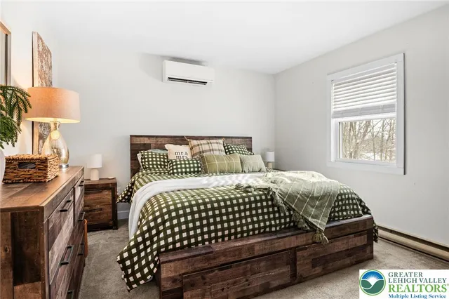 a bedroom with a bed and a lamp with window