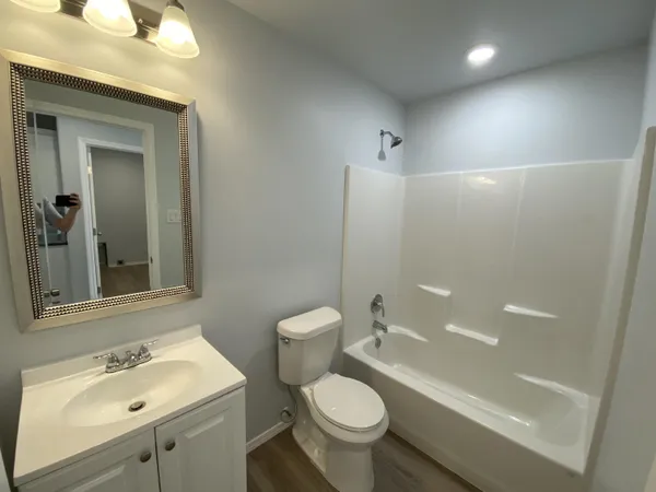 a bathroom with a sink toilet tub and shower