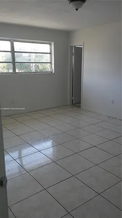 a white toilet sitting next to a shower