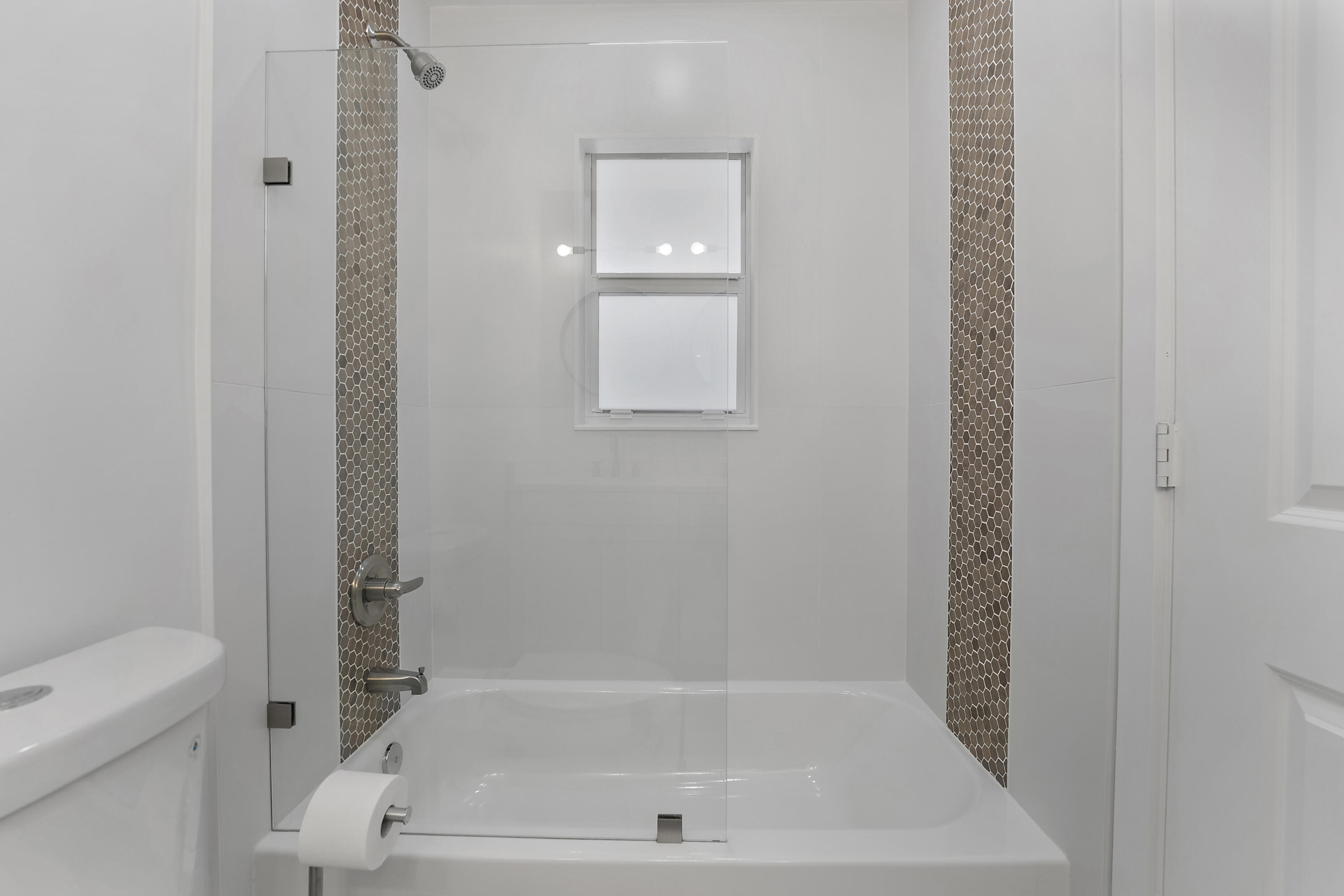 1279 Beach Road, Unit 3 Singer Island, FL 33404 - Photo 14 of 23 a bathroom with a bathtub