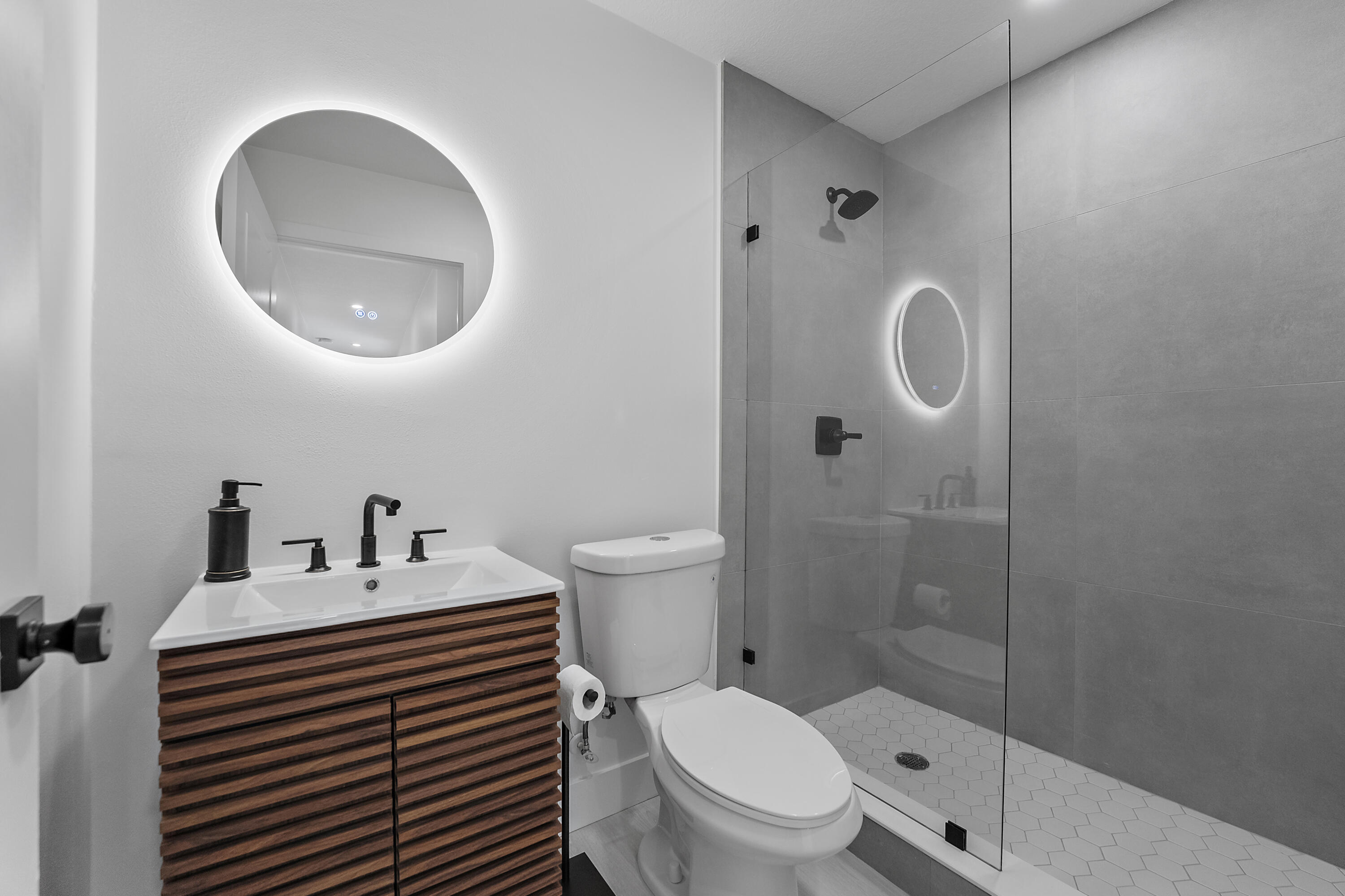 1279 Beach Road, Unit 3 Singer Island, FL 33404 - Photo 17 of 23 a bathroom with a sink a toilet and a mirror