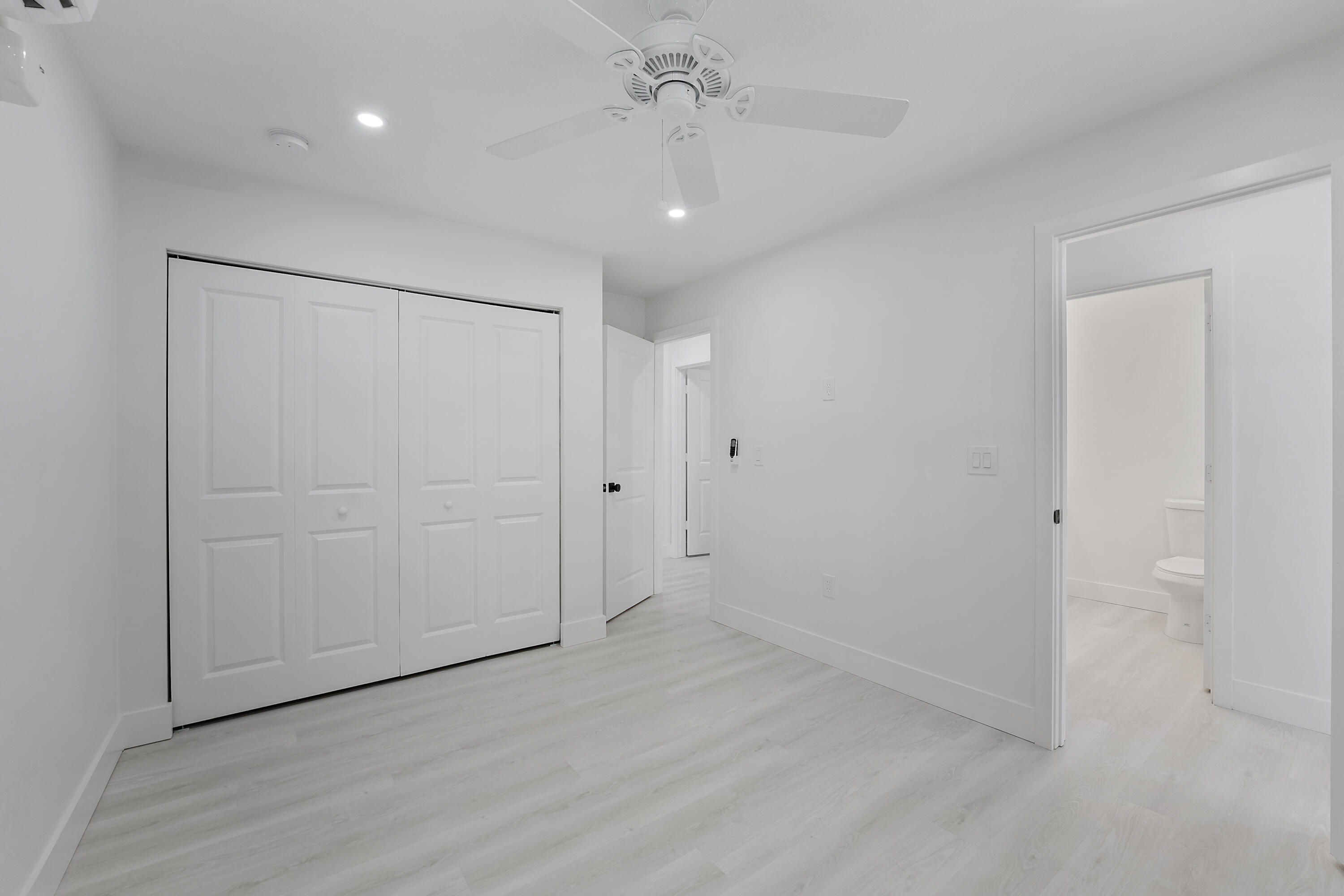 1279 Beach Road, Unit 3 Singer Island, FL 33404 - Photo 20 of 23 wooden floor in an empty room with a bathroom