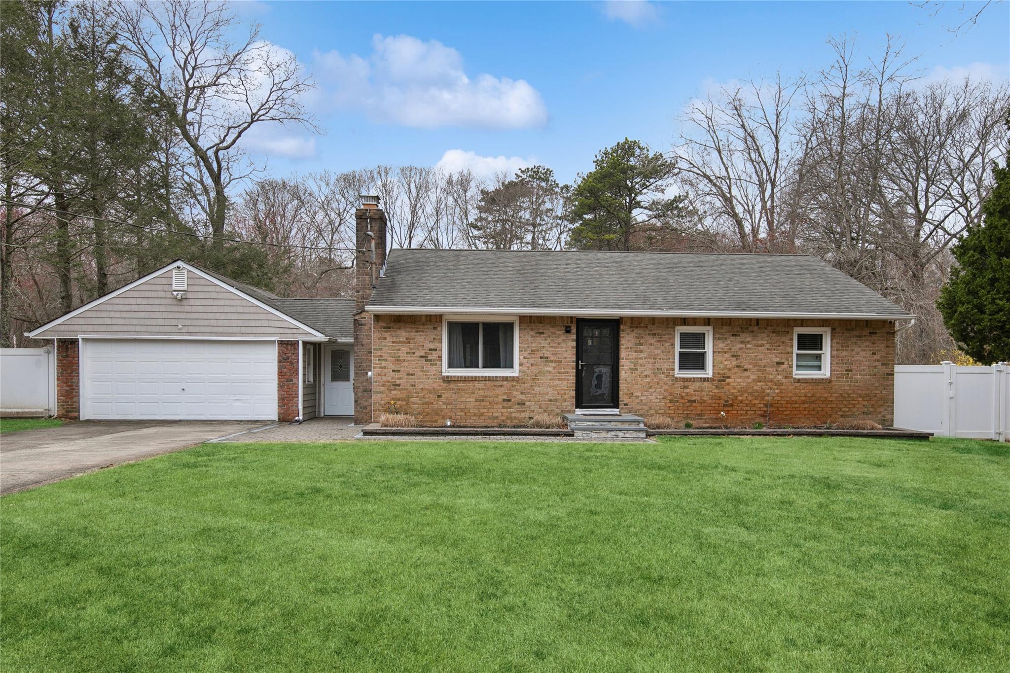 20 Ruth Lane Ridge, NY 11961 - Photo 1 of 1 Ranch-style home featuring driveway, brick siding, and fence