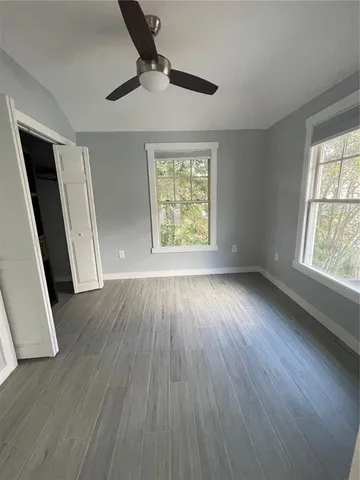 wooden floor in an empty room with a window