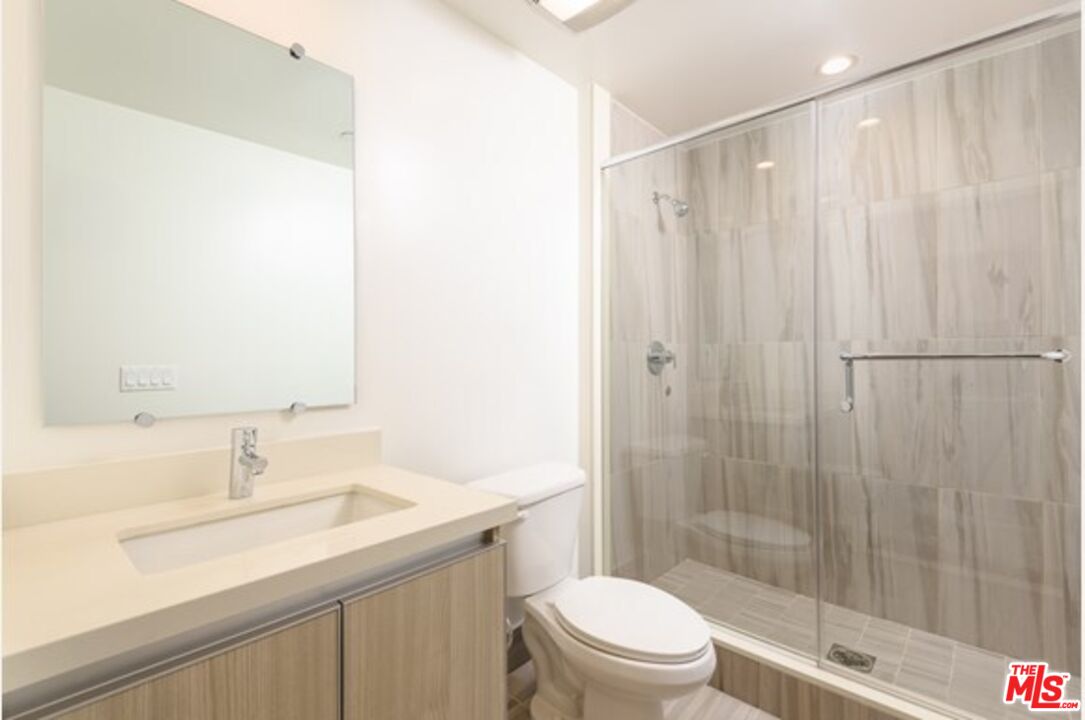 129 South Kings Road, Unit PH5 Los Angeles, CA 90048 - Photo 12 of 14 a bathroom with a sink a toilet and shower
