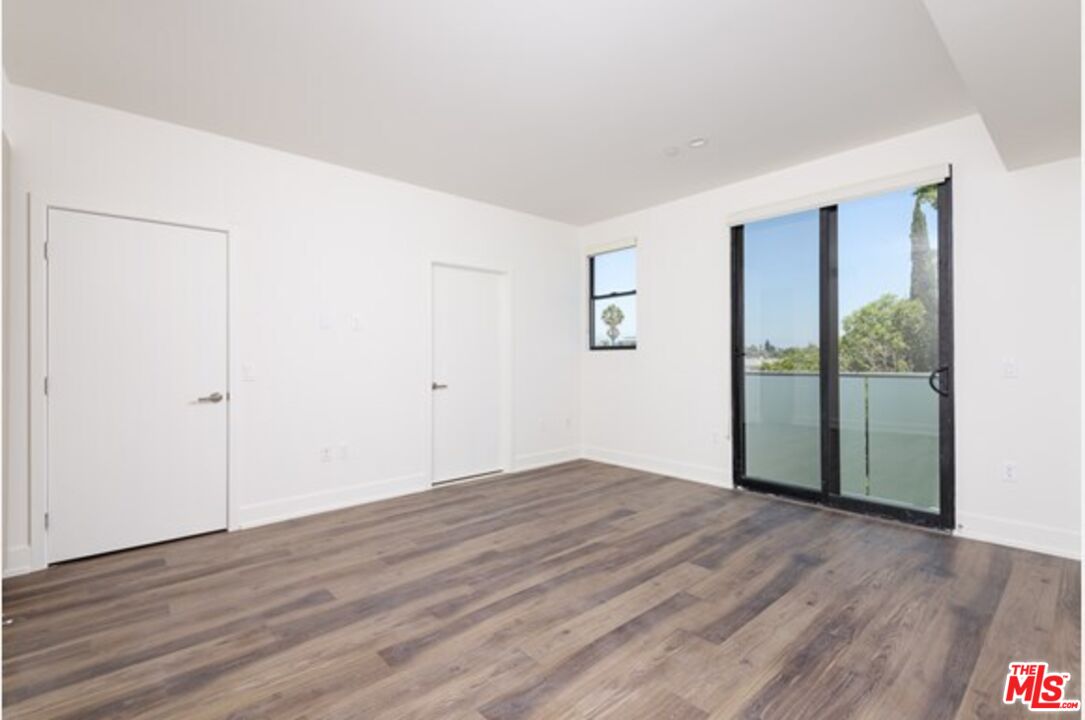 129 South Kings Road, Unit PH5 Los Angeles, CA 90048 - Photo 7 of 14 a view of a room with wooden floor and a window