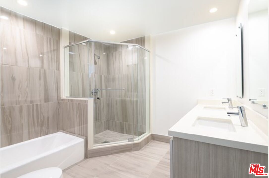 129 South Kings Road, Unit PH5 Los Angeles, CA 90048 - Photo 8 of 14 a bathroom with a sink and a mirror