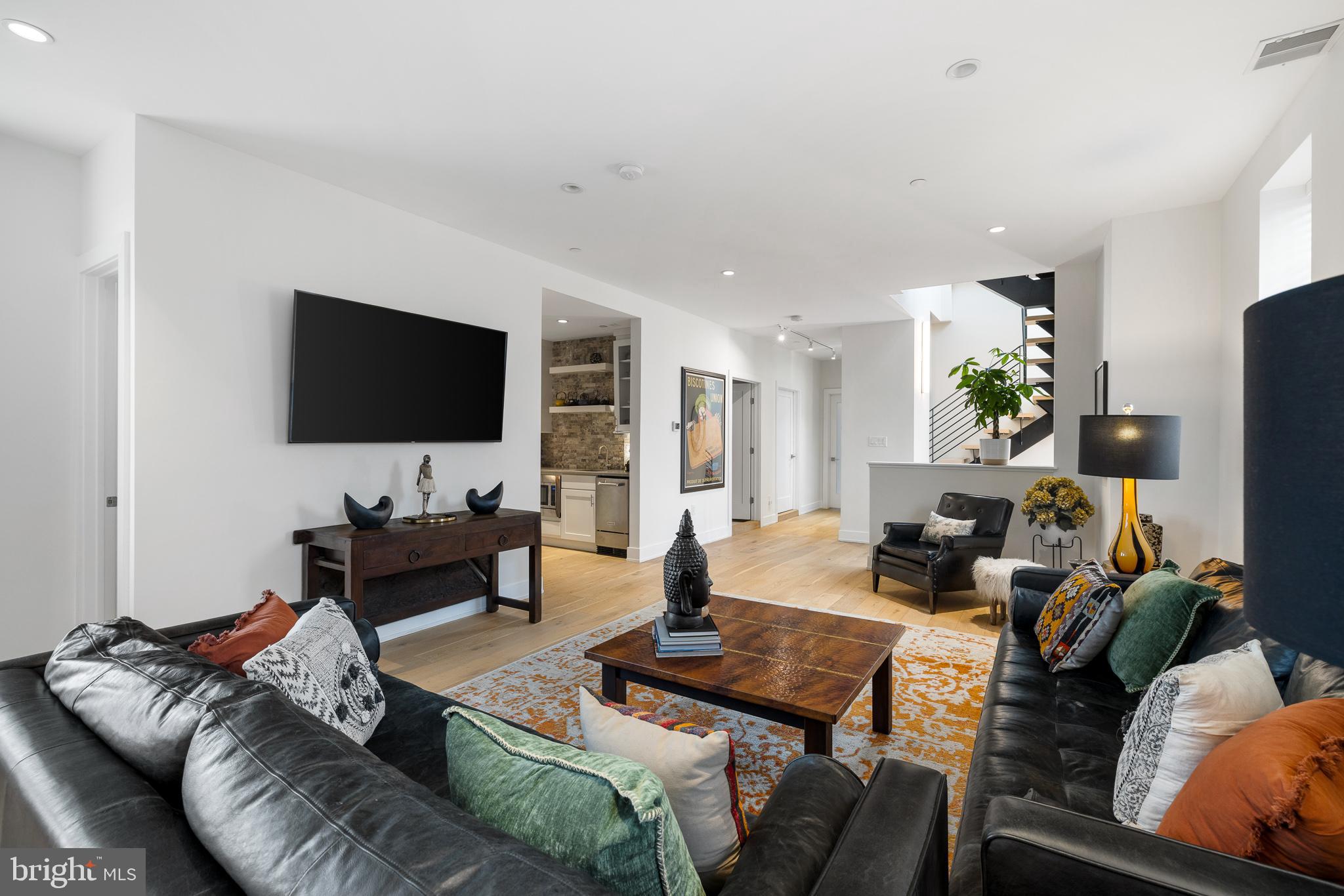 20 Letitia Street, Unit 5B Philadelphia, PA 19106 - Photo 17 of 44 a living room with furniture and a flat screen tv
