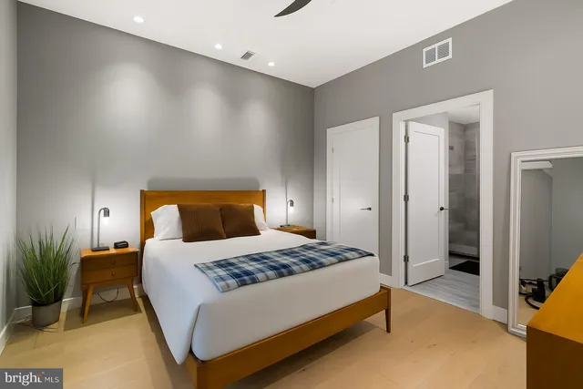 a bedroom with a bed and a table