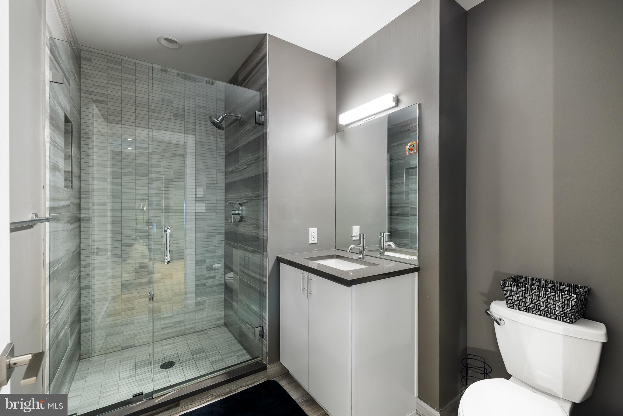 20 Letitia Street, Unit 5B Philadelphia, PA 19106 - Photo 38 of 44 a bathroom with a granite countertop sink toilet and shower