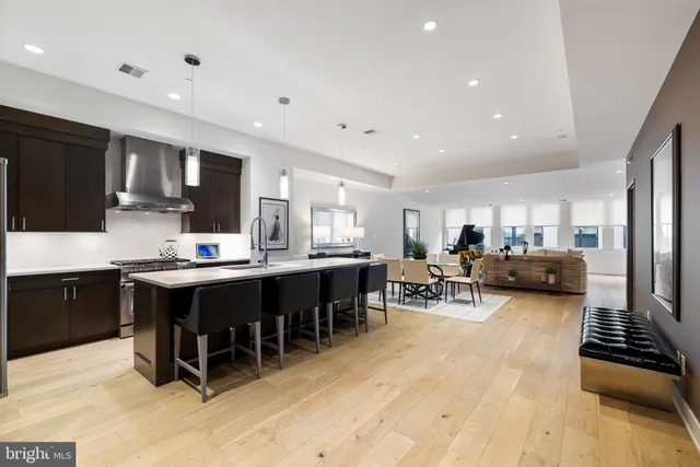 a large kitchen with kitchen island a sink table and chairs