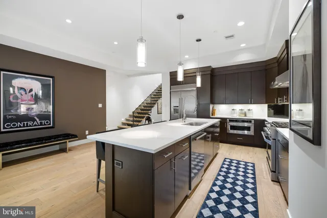 a kitchen with a sink appliances and cabinets