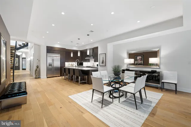 a living room with furniture and kitchen view