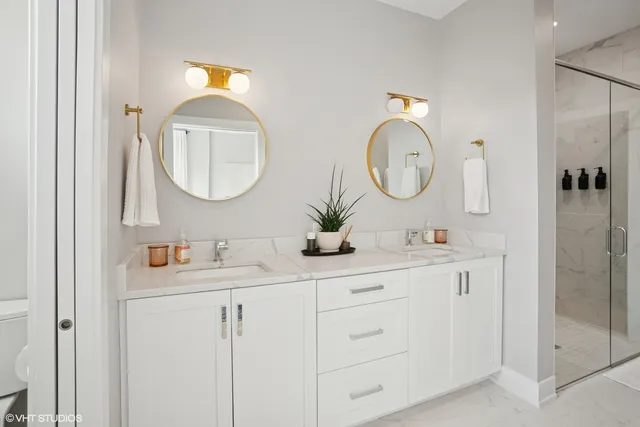a bathroom with double vanity sink and a mirror