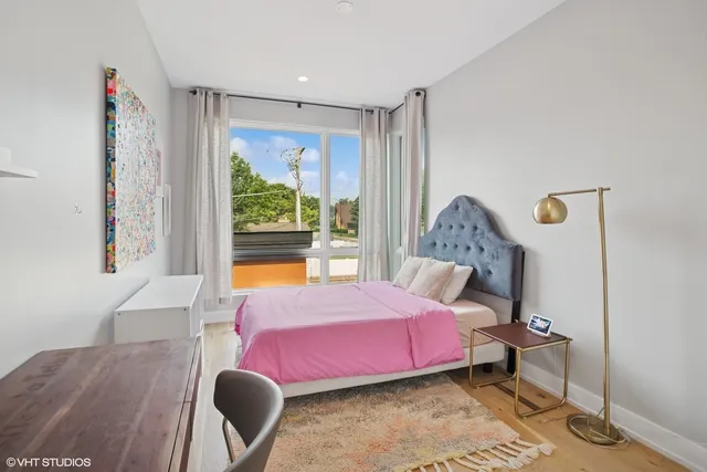 a bedroom with a bed and wooden floor