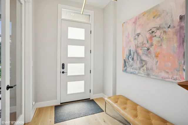 a view of front door with wooden floor